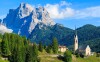 Church on top of hill in village of Pian near Selva di Cadore and beautiful mountains view, South Tirol, Dolomiti Mountains, Italy _